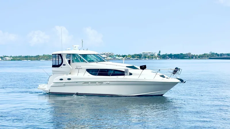 Slide: The Image of Starboard Profile View The 2006 Sea Ray 40 Motor Yacht, 'Knot on Call', showcases a sleek starboard profile against serene waters. Its elegant lines and spacious cabin windows emphasize the yacht's luxurious design and ample natural light. The flybridge and aft deck offer versa - 7150657