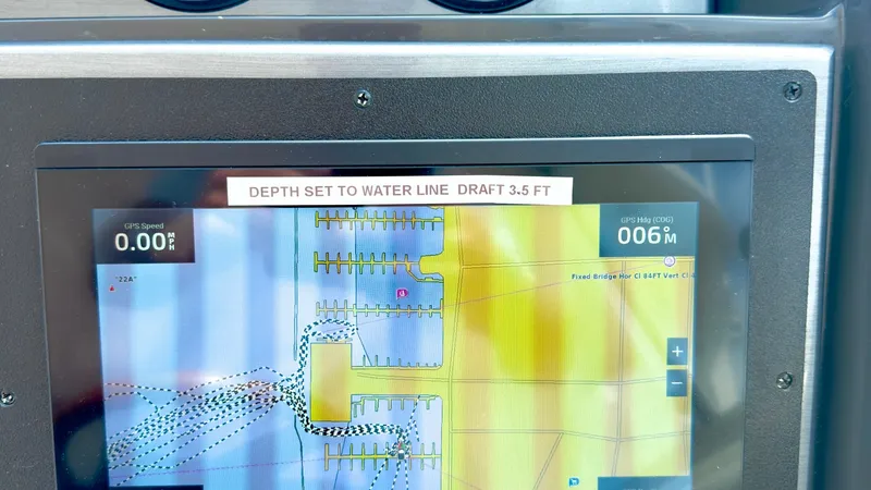 Slide: The Image of Navigation Display with Depth Settings The image features the navigation display of the 2006 Sea Ray 40 Motor Yacht, Knot on Call. The screen shows detailed electronic charts with depth settings prominently set to a draft of 3.5 feet. This advanced system aids in precise navigation, ensuring a - 7150630
