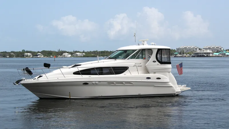 Slide: The Image of Side Profile of Sea Ray 40 Motor Yacht This image showcases the sleek side profile of the 2006 Sea Ray 40 Motor Yacht, 'Knot on Call'. The yacht features a streamlined design with large, tinted windows that offer expansive views and abundant natural light. The elegant exterior is complemented - 7150658