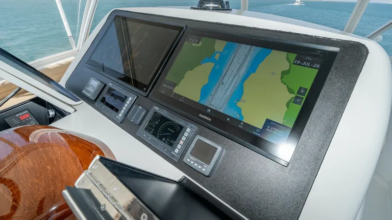 Slide: The Image of Flybridge Helm with Navigation Displays The flybridge helm of the 2017 Viking 55 Convertible showcases advanced navigation technology with dual large-screen displays, offering clear and precise route mapping. The control panel is sleek and modern, featuring high-quality instrumentation and poli - 7180054