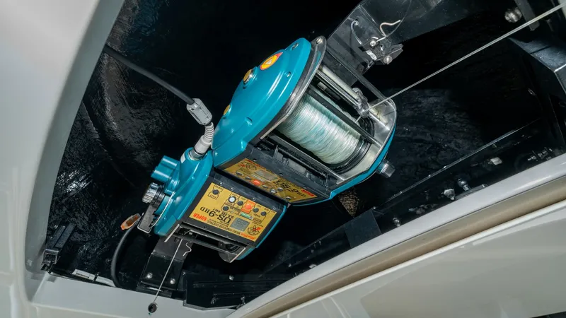 Slide: The Image of Overhead Fishing Equipment Compartment This image showcases the overhead compartment featuring advanced fishing equipment on the 2017 Viking 55 Convertible. The compartment is equipped with a robust electric reel system, ideal for deep-sea fishing enthusiasts. The sleek design and practical in - 7180053
