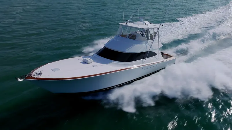 The Image of Aerial View of Viking 55 Convertible The 2017 Viking 55 Convertible 'Marilee' is showcased in motion, cutting through the waves with precision. Its sleek hull design and aerodynamic superstructure ensure optimal performance and speed. The flybridge offers an elevated vantage point, perfect f - 7180021