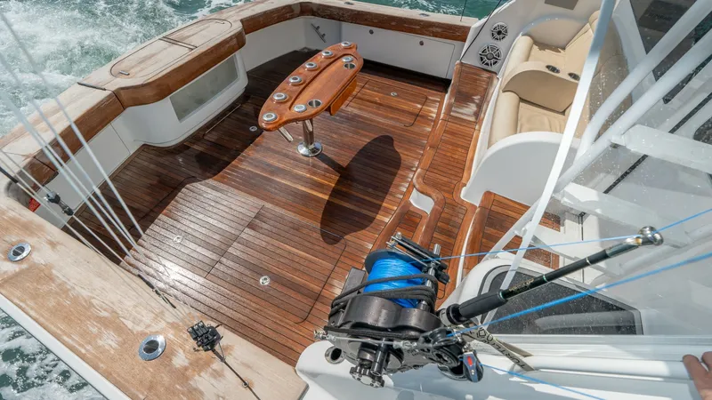 Slide: The Image of Spacious Teak Cockpit with Seating The cockpit of the 2017 Viking 55 Convertible showcases a beautifully crafted teak deck, ideal for both fishing and relaxation. Equipped with a stylish fighting chair and ample seating, this area provides comfort and functionality. The wrap-around bench a - 7180067
