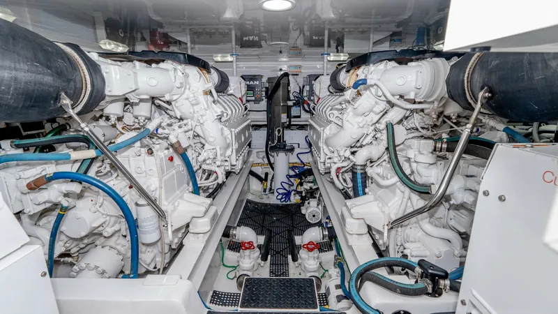 Slide: The Image of Engine Room with Dual Engines The engine room of the 2017 Viking 55 Convertible showcases twin powerful engines meticulously arranged for optimal performance. The space is well-organized, with clearly labeled control systems and easy access to essential components, ensuring efficient - 7180069