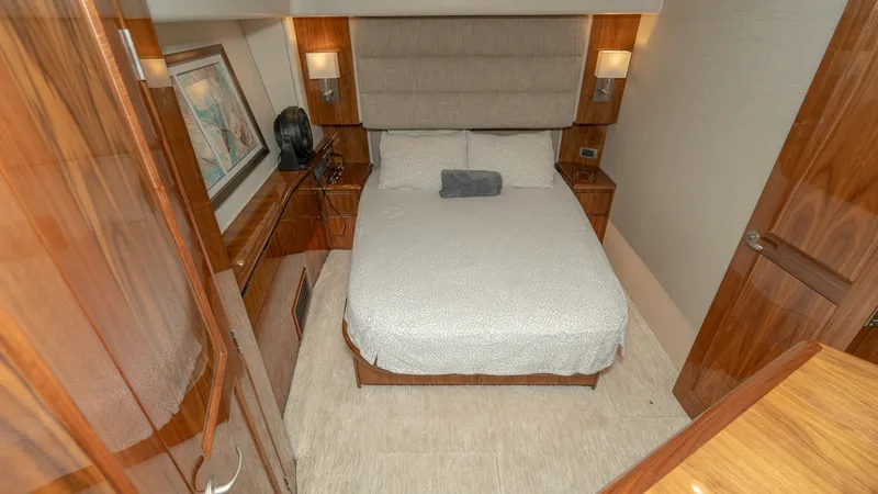Slide: The Image of Cozy Stateroom with Queen Bed This inviting stateroom features a comfortable queen-sized bed with elegant wood finishes throughout. The room is adorned with ambient lighting and tasteful artwork, creating a warm, serene atmosphere. Ample storage and modern amenities ensure a luxurious - 7180045