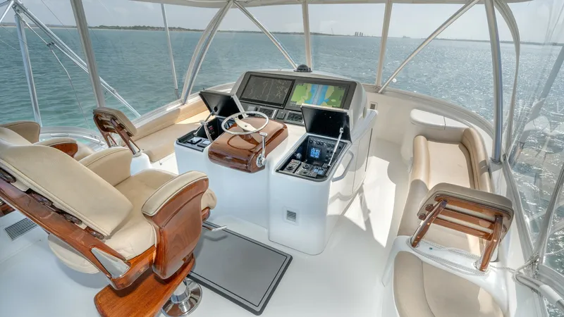 Slide: The Image of Flybridge Helm with Seating Area The flybridge of the 2017 Viking 55 Convertible features a state-of-the-art helm station with dual multifunction displays, ensuring optimal navigation and control. Luxurious captain's chairs with polished wood accents provide comfort and style, while addi - 7180023