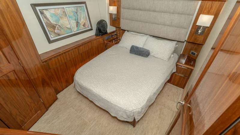 Slide: The Image of Luxurious Master Stateroom Interior The master stateroom of the Viking 55 Convertible 'Marilee' offers a refined retreat with its plush queen-sized bed and elegant wood finishes. Soft, ambient lighting and tasteful artwork create a welcoming atmosphere, while ample storage options ensure fu - 7180038