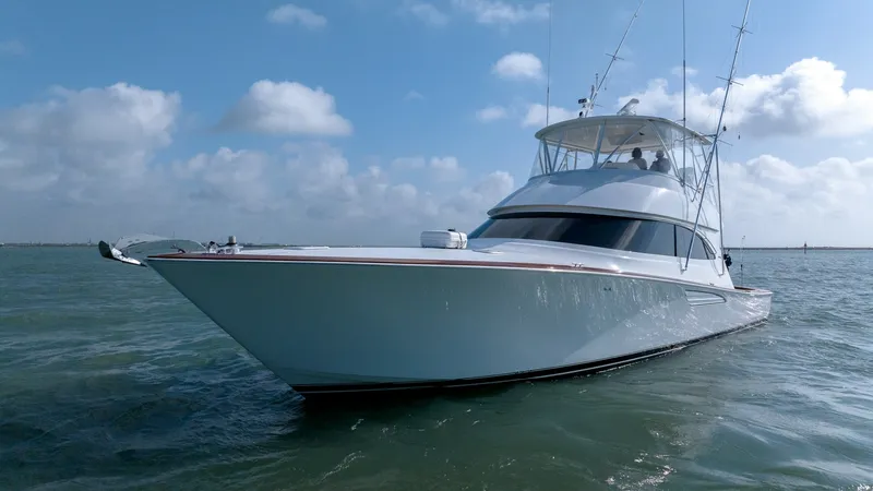 Slide: The Image of Bow View of Viking 55 Convertible The Viking 55 Convertible showcases its sleek bow cutting through the water with precision. The vessel's aerodynamic design and robust construction are evident, offering both style and performance. This angle highlights the yacht's elegant lines and the s - 7180080