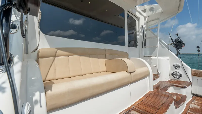 Slide: The Image of Aft Deck Seating Area The aft deck of the 2017 Viking 55 Convertible features plush, beige cushioned seating, ideal for relaxation while enjoying the open sea views. The sleek design is complemented by rich wood finishes, adding a touch of elegance to the outdoor space. This a - 7180068