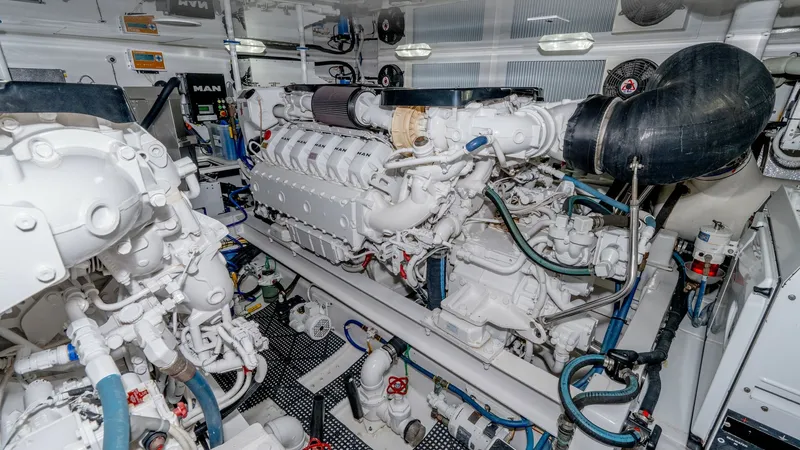 Slide: The Image of Engine Room with Twin MAN Engines The engine room of the 2017 Viking 55 Convertible showcases powerful twin MAN engines, emphasizing superior performance and reliability. The space is meticulously organized with easy access to essential components, ensuring efficient maintenance. Bright l - 7180071