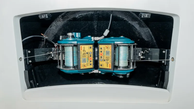 Slide: The Image of Fishing Reel Compartment This image showcases the fishing reel compartment of the 2017 Viking 55 Convertible. The compartment is neatly integrated into the vessel's structure, housing dual electric reels for efficient fishing operations. The setup is designed for easy access and - 7180052