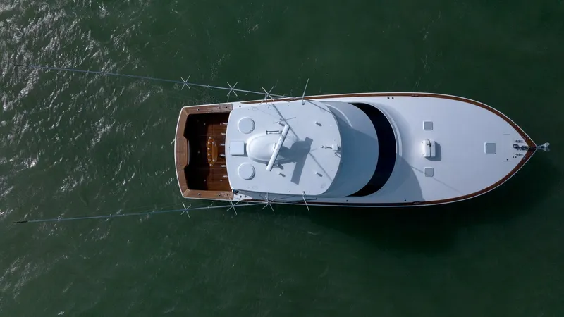 Slide: The Image of Aerial View of Flybridge and Deck This aerial shot showcases the sleek design of the Viking 55 Convertible's flybridge and deck. The expansive flybridge offers excellent visibility for navigation, while the spacious aft deck is ideal for fishing or entertaining. The vessel's streamlined p - 7180085