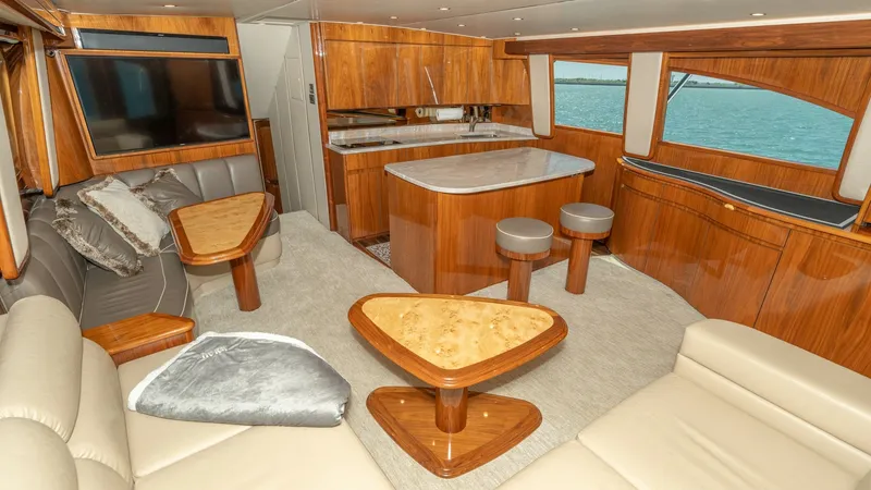 Slide: The Image of Spacious Salon with Elegant Seating The salon of the 2017 Viking 55 Convertible features luxurious leather seating and beautifully crafted wood finishes. A large flat-screen TV complements the entertainment space, while ample windows provide stunning ocean views. The open layout enhances co - 7180035