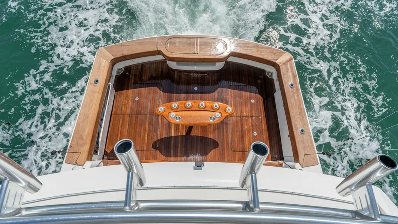 Slide: The Image of Teak Aft Deck with Rod Holders This image showcases the elegant teak aft deck of the Viking 55 Convertible, featuring a well-equipped fishing station with multiple rod holders. The beautifully finished wood accentuates the vessel's craftsmanship and provides ample space for angling act - 7180059