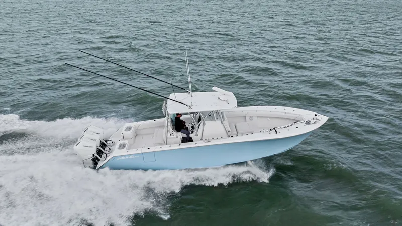 Slide: The Image of Aerial View of 35 Tournament Cruising The 2024 Sea Hunter 35 Tournament is captured slicing through the waves with precision. This powerful vessel features a sleek hull design, complemented by dual outboard engines for exceptional performance. The spacious deck layout is ideal for fishing ent - 7094887