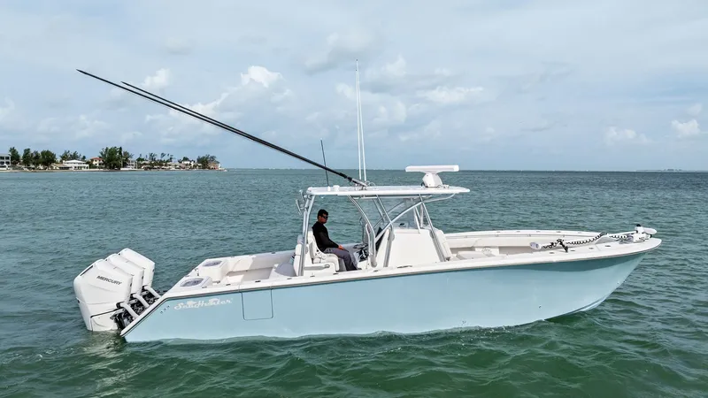 Slide: The Image of Side Profile of Sea Hunter 35 Tournament This image showcases the sleek side profile of the 2024 Sea Hunter 35 Tournament, highlighting its spacious deck and powerful dual outboard engines. The center console layout provides ample space for navigation and fishing, while the elegant design ensure - 7094883
