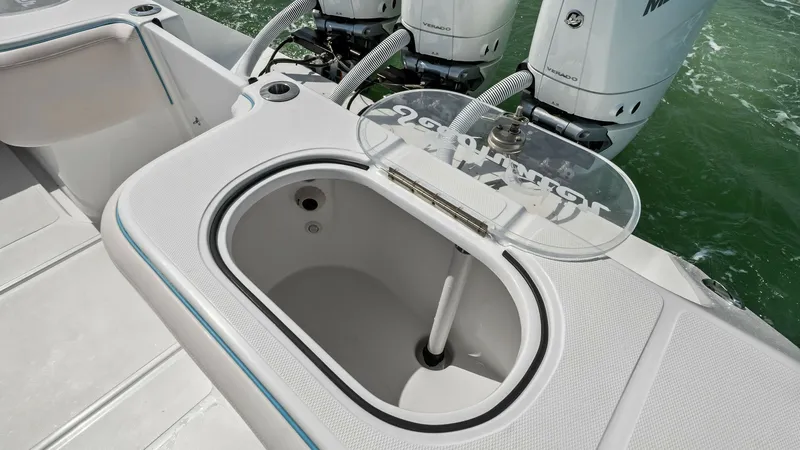 Slide: The Image of Aft Deck Live Well and Engines The 2024 Sea Hunter 35 Tournament features a spacious aft deck equipped with a well-designed live well, perfect for keeping bait fresh. The sleek fiberglass finish complements the powerful twin outboard engines, ensuring high performance on the water. Thi - 7094869