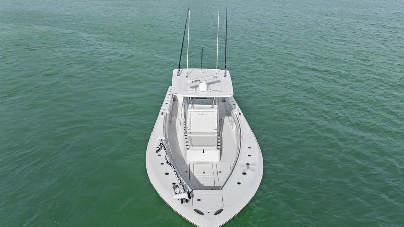 Slide: The Image of Aerial View of Bow Deck The 2024 Sea Hunter 35 Tournament showcases a spacious bow deck, ideal for fishing and leisure. The clean lines and ample seating provide functionality and comfort, while the elevated helm station ensures excellent visibility. Equipped with multiple rod h - 7094881