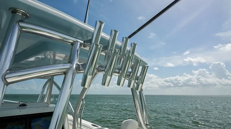 Slide: The Image of Hardtop with Rod Holders and Sea View The 2024 Sea Hunter 35 Tournament features a robust hardtop equipped with multiple stainless steel rod holders, ideal for avid anglers. The clean, sleek design enhances the vessel's sporty aesthetic while providing practical functionality. Enjoy panoramic - 7094865