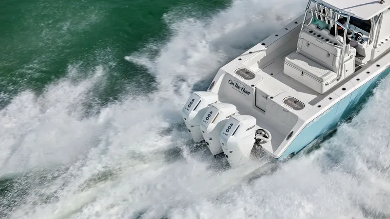 Slide: The Image of Aft Deck with Triple Outboard Engines The 2024 Sea Hunter 35 Tournament showcases a powerful aft deck equipped with triple 300 HP outboard engines, providing exceptional speed and performance. The spacious deck features comfortable seating and ample storage, ideal for long fishing trips or le - 7094892