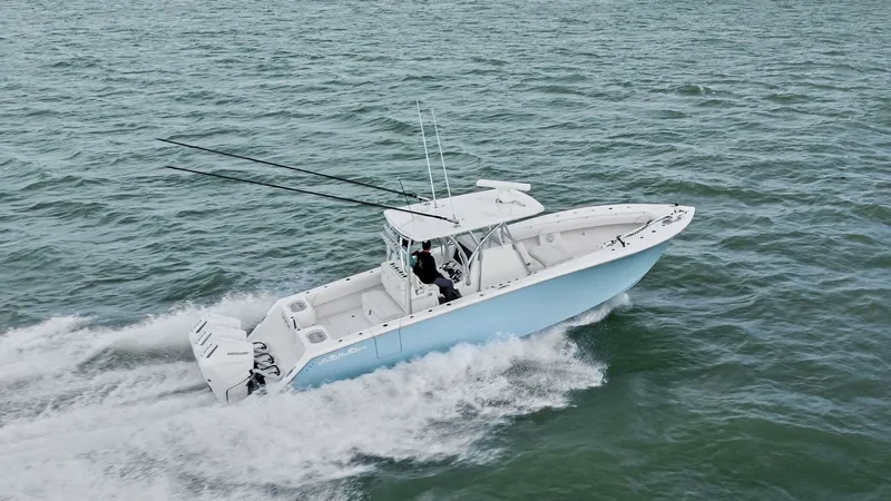 Slide: The Image of Aerial View of 35 Tournament Cruising The 2024 Sea Hunter 35 Tournament is captured cruising effortlessly across open waters. This dynamic center console design showcases a spacious deck, ideal for fishing and leisure, with twin powerful engines ensuring top performance. Its sleek lines and m - 7094886