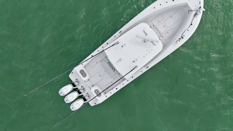 Slide: The Image of Aerial View of Fishing Deck This aerial view showcases the spacious fishing deck of the 2024 Sea Hunter 35 Tournament. The deck is designed for optimal angling with ample room for movement, complemented by dual outboard engines for exceptional power and speed. The streamlined layout - 7094882