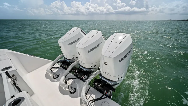 Slide: The Image of Triple Outboard Engines on Aft Deck The 2024 Sea Hunter 35 Tournament showcases its powerful triple outboard engines, providing exceptional performance and speed for serious anglers. The sleek design and efficient layout of the aft deck ensure easy access and maintenance, making it ideal fo - 7094870