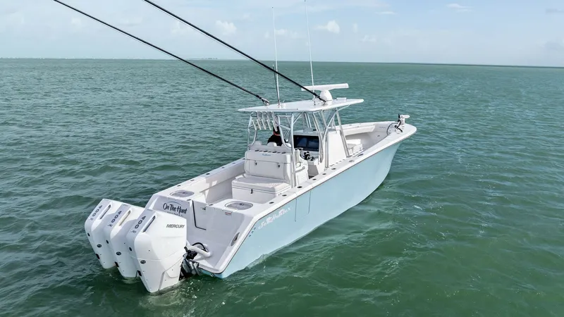 Slide: The Image of Aerial View of Aft Deck and Engines The 2024 Sea Hunter 35 Tournament showcases its powerful triple engines, ideal for high-speed offshore adventures. The spacious aft deck offers ample room for fishing activities, enhanced by a sleek, modern design. Its light blue hull complements the open - 7094884