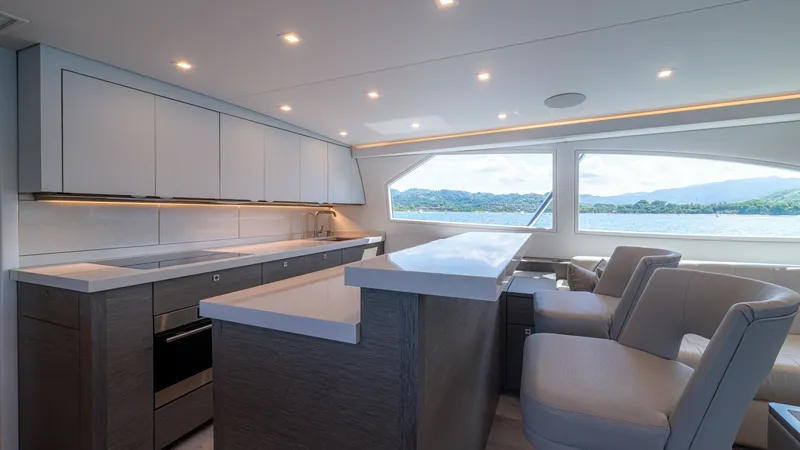 Slide: The Image of Galley with Scenic View This sleek galley on the 2024 Viking 64 Convertible features contemporary cabinetry and high-end appliances, perfect for culinary endeavors at sea. Expansive windows flood the space with natural light, offering stunning views of the surrounding waters. Th - 7162548