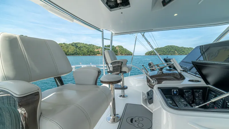 Slide: The Image of Flybridge Helm Station The flybridge helm station of the 2024 Viking 64 Convertible offers a commanding view of the surrounding seascape. Equipped with advanced navigation displays and ergonomic seating, it ensures both comfort and functionality for the captain. The sleek desig - 7162592