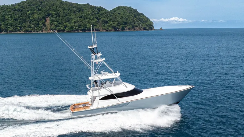 Slide: The Image of Viking 64 Convertible at Sea The 2024 Viking 64 Convertible, named 'Fish Tank', is captured cruising effortlessly through open waters, showcasing its sleek and powerful design. The vessel features a striking white hull with elegant lines, complemented by a spacious aft deck ideal for - 7162619