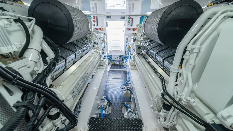 Slide: The Image of Engine Room with Twin Engines This image showcases the powerful engine room of the 2024 Viking 64 Convertible, featuring twin high-performance engines. The space is meticulously organized with easy access to critical components, ensuring optimal maintenance and operation. The clean, w - 7162604
