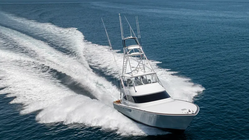 Slide: The Image of Dynamic Aerial View of Bow This striking aerial shot captures the 2024 Viking 64 Convertible 'Fish Tank' cutting through the water with impressive speed and agility. The sleek bow design is complemented by a robust tower, showcasing its sportfishing capabilities and elegant craftsm - 7162622