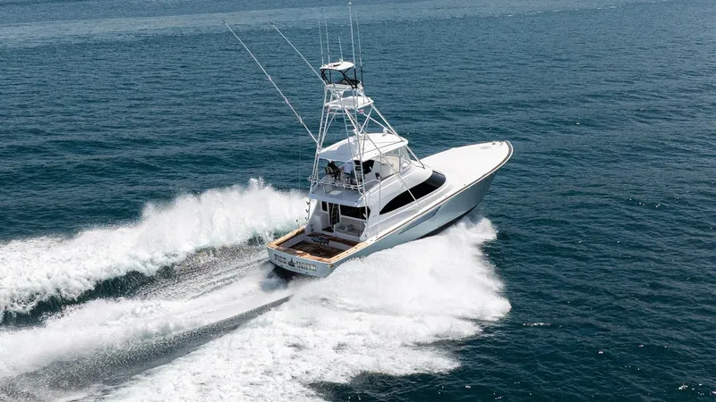 Slide: The Image of Aerial View of Viking 64 in Motion The 2024 Viking 64 Convertible, 'Fish Tank', cuts through the water with power and grace, showcasing its sleek hull design. The expansive aft deck is equipped for sportfishing, while the spacious flybridge offers commanding views. This vessel's performanc - 7162621