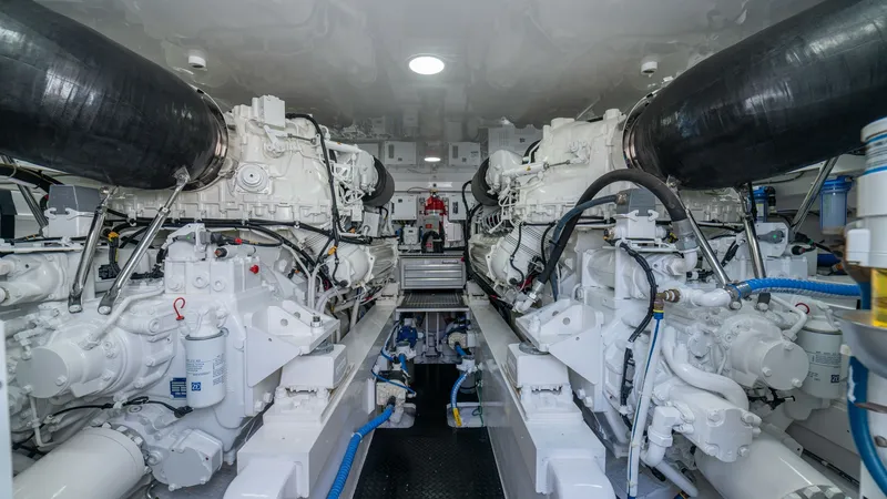 Slide: The Image of Engine Room with Twin Engines The engine room of the 2024 Viking 64 Convertible showcases twin powerful engines, meticulously organized to ensure optimal performance. The space is clean and well-ventilated, with neatly arranged hoses and wiring, reflecting Viking's commitment to engin - 7162603