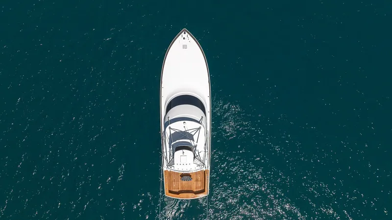 Slide: The Image of Aerial View of Bow and Deck This striking aerial view showcases the sleek bow and spacious deck of the 2024 Viking 64 Convertible. The vessel's elegant lines are complemented by the teak deck, offering a perfect blend of style and functionality. Ideal for both fishing and leisure, t - 7162626