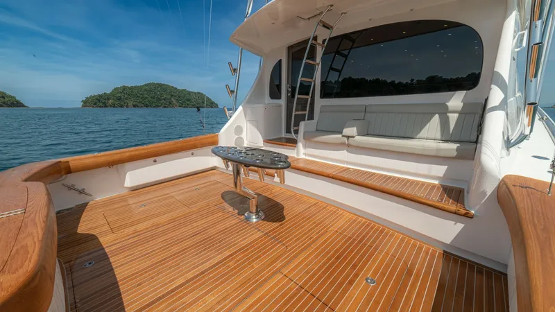 Slide: The Image of Spacious Teak Cockpit Area The cockpit of the 2024 Viking 64 Convertible 'Fish Tank' showcases a beautifully crafted teak deck, providing a luxurious and durable surface. The space is designed for both relaxation and fishing, featuring a central mounted table and ample seating. Lar - 7162583