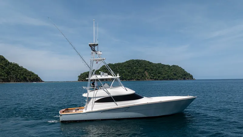 The Image of Profile 2024 Viking 64 Convertible This striking side profile showcases the sleek lines and robust design of the 2024 Viking 64 Convertible. The vessel features a prominent tuna tower for enhanced visibility and advanced fishing capabilities. Its aerodynamic hull and elegant white finish h - 7162539