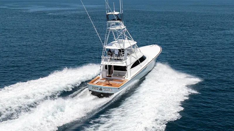Slide: The Image of Aerial View of Aft Deck and Tower This striking aerial shot showcases the aft deck and towering structure of the 2024 Viking 64 Convertible, 'Fish Tank'. The spacious teak aft deck is perfect for fishing or lounging, while the command tower provides excellent visibility for navigation. Th - 7162629