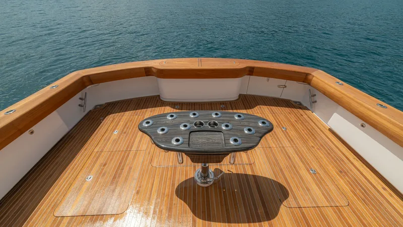 Slide: The Image of Spacious Teak Cockpit with Rod Holders This image features the expansive cockpit of the 2024 Viking 64 Convertible, showcasing beautifully finished teak flooring. The central fighting chair with multiple rod holders is ideal for serious fishing enthusiasts. The cockpit's open layout offers amp - 7162584