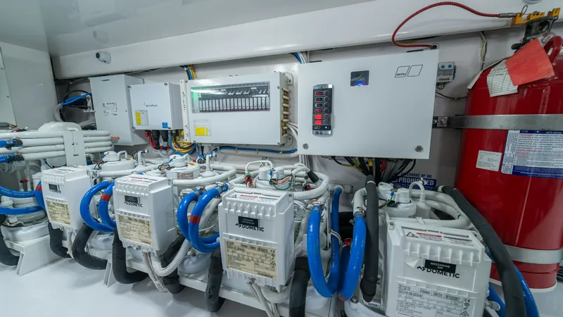Slide: The Image of Engine Room with Electrical Systems This image showcases the engine room of the 2024 Viking 64 Convertible, featuring a well-organized array of electrical systems. The neatly arranged components highlight advanced technology and efficient layout, ensuring optimal performance and reliability - 7162606
