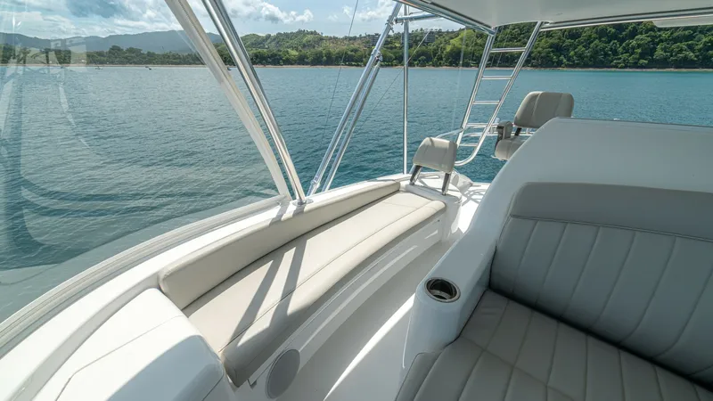 Slide: The Image of Flybridge Seating with Ocean View The Flybridge of the 2024 Viking 64 Convertible offers luxurious seating with plush cushions and a sleek, modern design. This area provides panoramic views of the surrounding waters, ideal for relaxation or navigation. The seating is complemented by a bui - 7162600