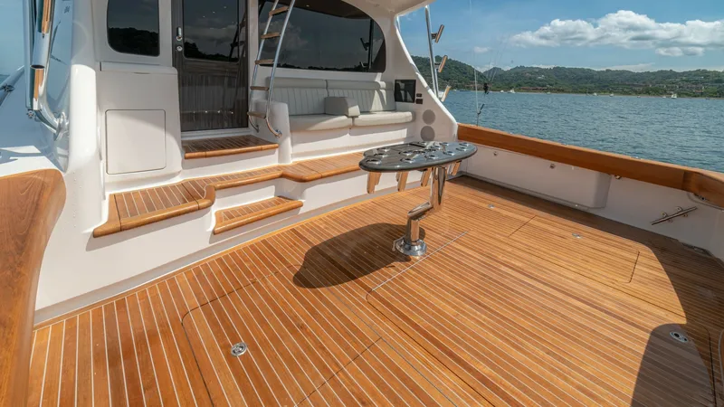 Slide: The Image of Spacious Teak Cockpit Area The cockpit of the 2024 Viking 64 Convertible features a beautifully crafted teak deck, offering ample space for relaxation and fishing activities. Equipped with a sleek pedestal table and comfortable seating, this area is perfect for entertaining or enjo - 7162582
