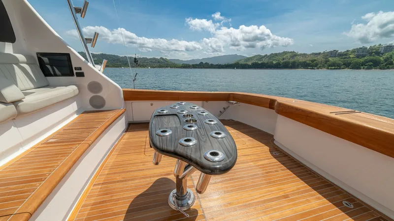 Slide: The Image of Spacious Aft Deck with Fishing Station The aft deck of the 2024 Viking 64 Convertible 'Fish Tank' showcases a sleek fishing station with multiple rod holders, perfect for avid anglers. The teak decking and comfortable built-in seating provide both functionality and comfort, while the polished - 7162587