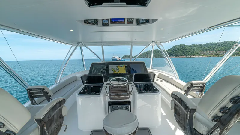 Slide: The Image of Flybridge Helm with Seating The flybridge helm of the 2024 Viking 64 Convertible offers a commanding view with state-of-the-art navigation displays and controls. Surrounded by comfortable seating, this area is designed for both functionality and relaxation, featuring high-quality ma - 7162540
