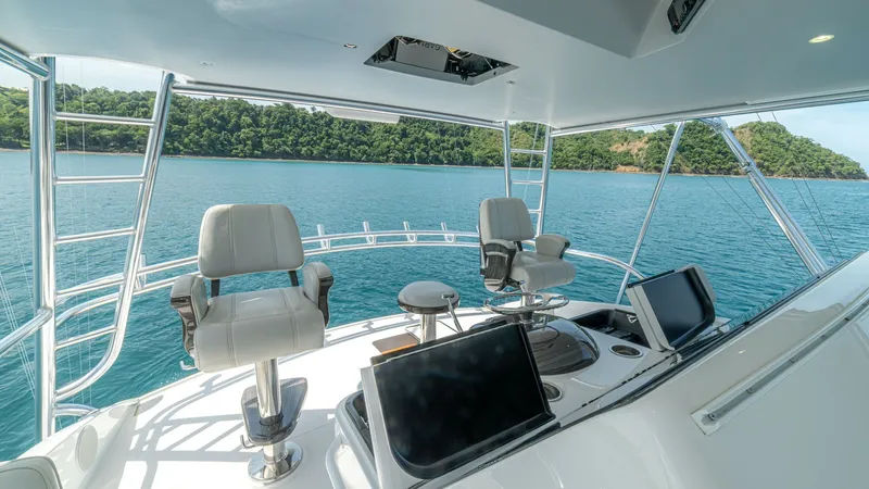 Slide: The Image of Flybridge Helm with Dual Seating The flybridge helm of the 2024 Viking 64 Convertible offers a commanding view with dual captain's chairs, providing ultimate comfort and control. The spacious layout is equipped with state-of-the-art navigation displays, allowing for seamless operation. S - 7162593