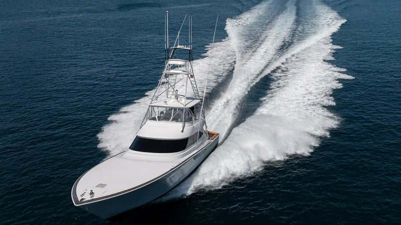 Slide: The Image of Aerial View of Bow in Motion The 2024 Viking 64 Convertible 'Fish Tank' showcases its sleek design and powerful performance as it cuts through the water. The image captures the dynamic bow view, emphasizing the vessel's graceful lines and robust hull. The open ocean backdrop highligh - 7162627