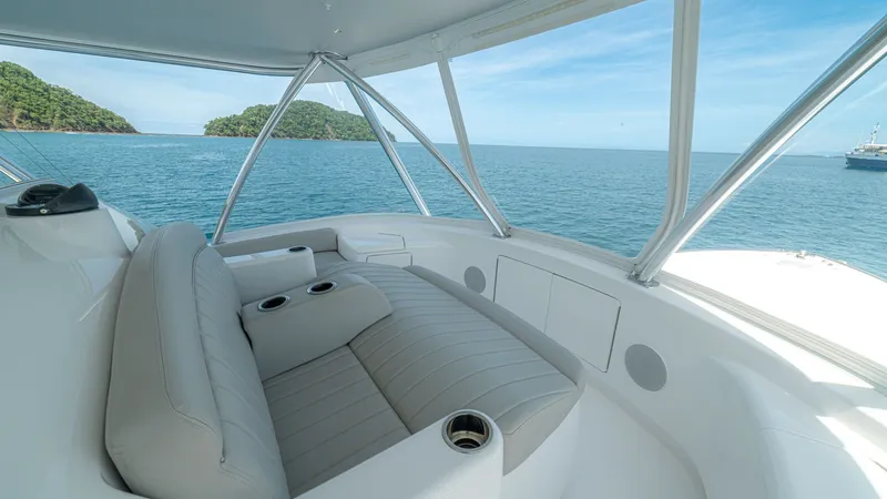 Slide: The Image of Flybridge Seating with Ocean View The flybridge of the 2024 Viking 64 Convertible 'Fish Tank' features plush, comfortable seating with integrated cup holders, perfect for enjoying the open sea views. The sleek, modern design is complemented by high-quality materials, providing both luxury - 7162602