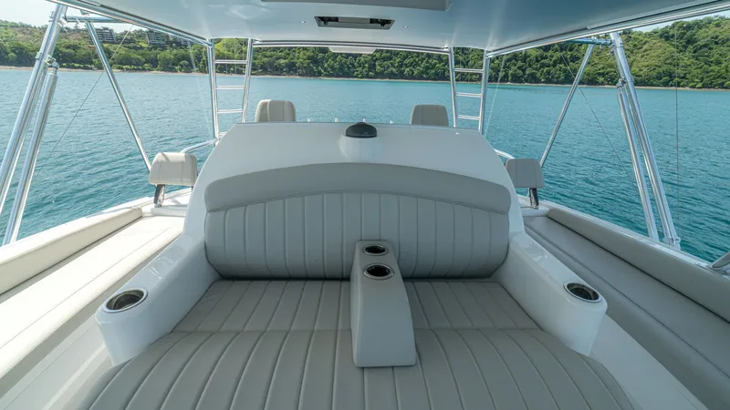Slide: The Image of Flybridge Seating Area Experience comfort and style on the Viking 64 Convertible's flybridge seating area. This space features plush, elegant upholstery with integrated cup holders, perfect for enjoying panoramic views of the water. The open design and high-quality materials en - 7162599