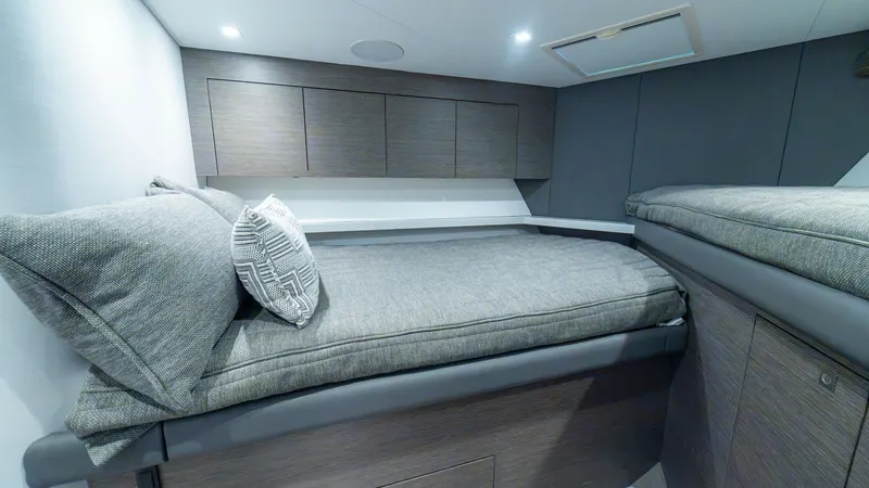 Slide: The Image of Guest Stateroom with Twin Berths This cozy guest stateroom features twin berths with plush bedding, offering comfort and style. The sleek cabinetry and soft LED lighting create a modern yet inviting atmosphere. Ample storage space and contemporary finishes enhance the functionality and a - 7162562